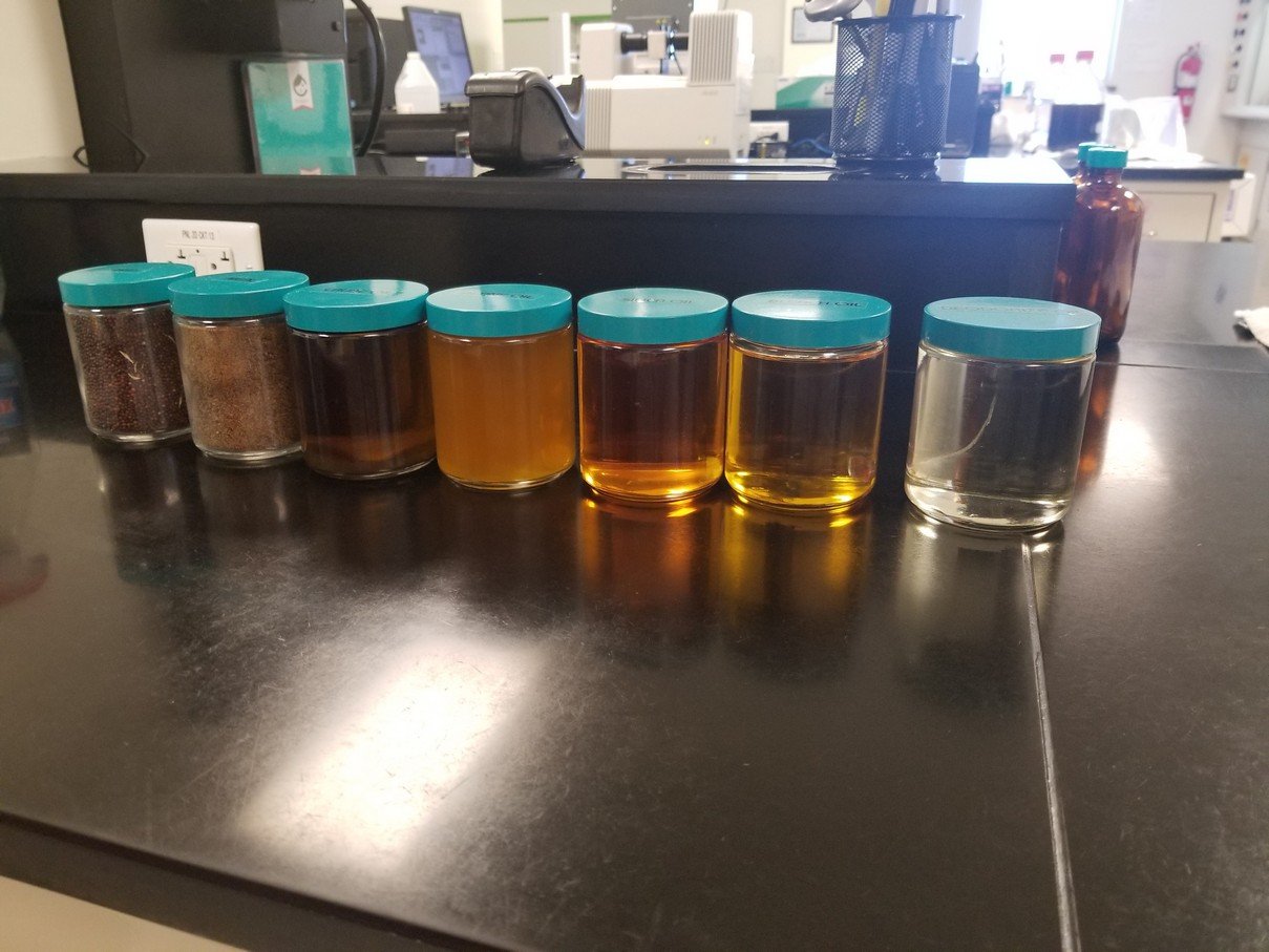 Laboratory jars containing samples of varying color and clarity