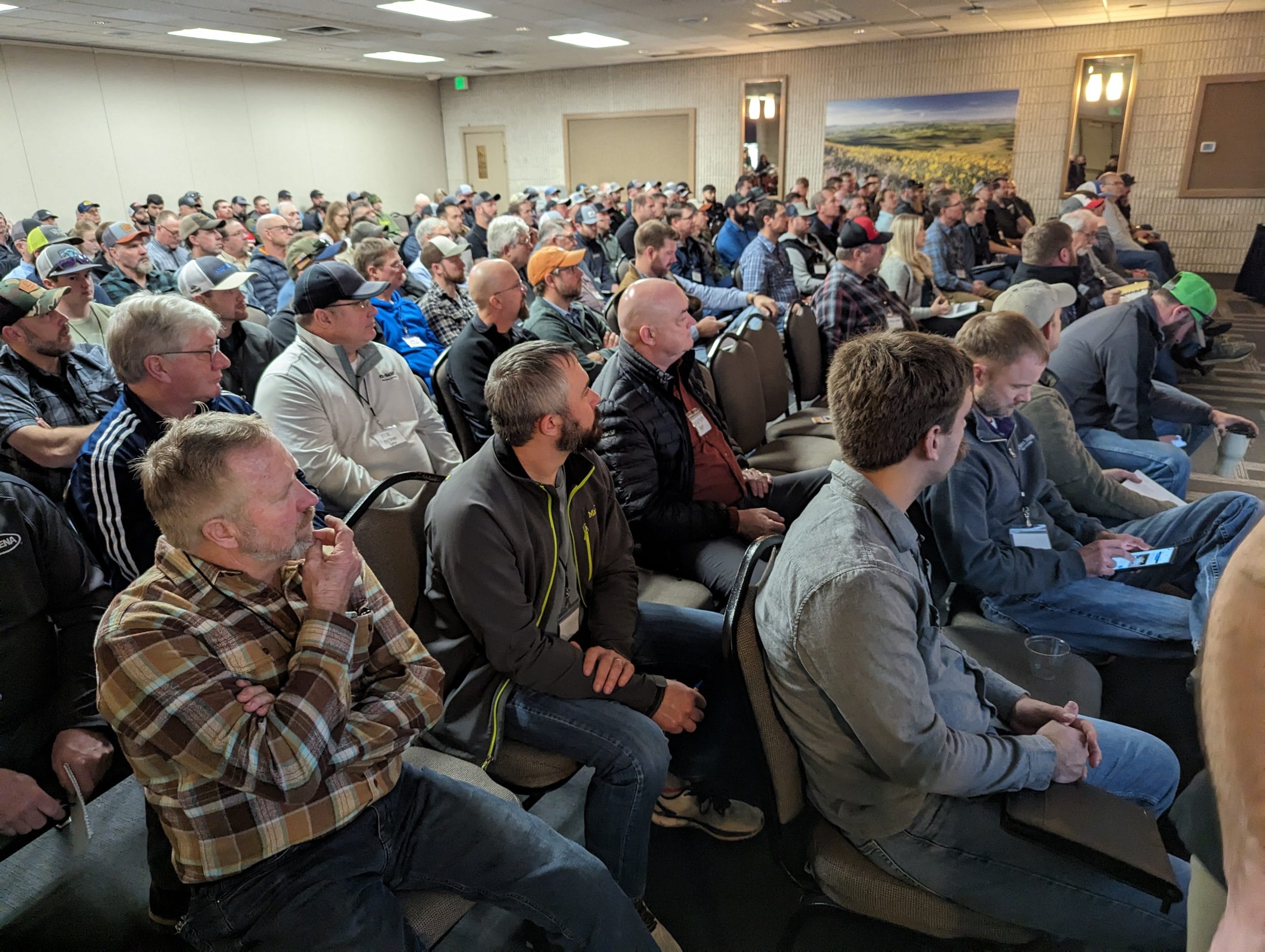 Large seated audience attending a conference presentation